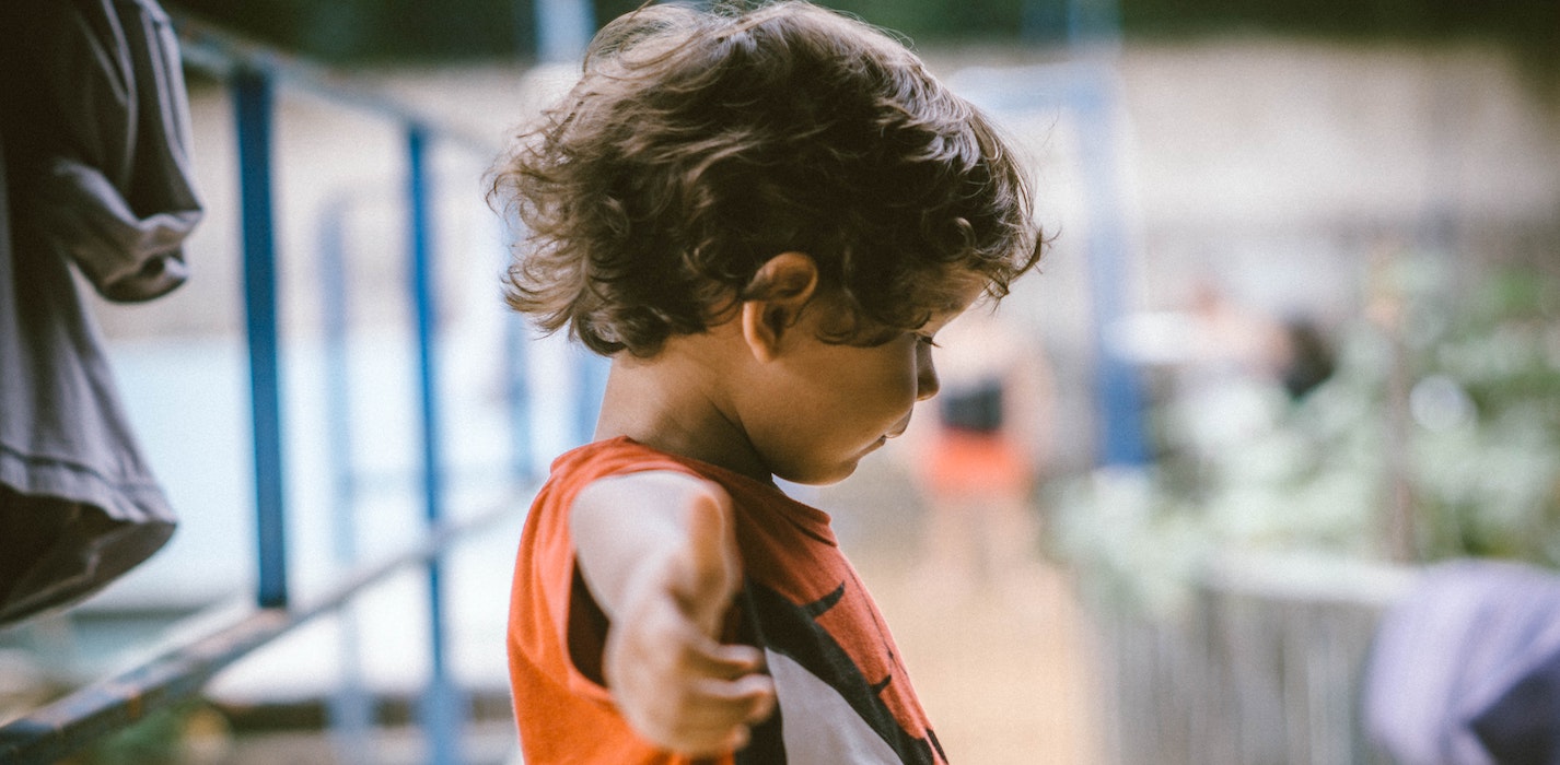 a picture showing a happy kid wearing a print-on-demand jersey