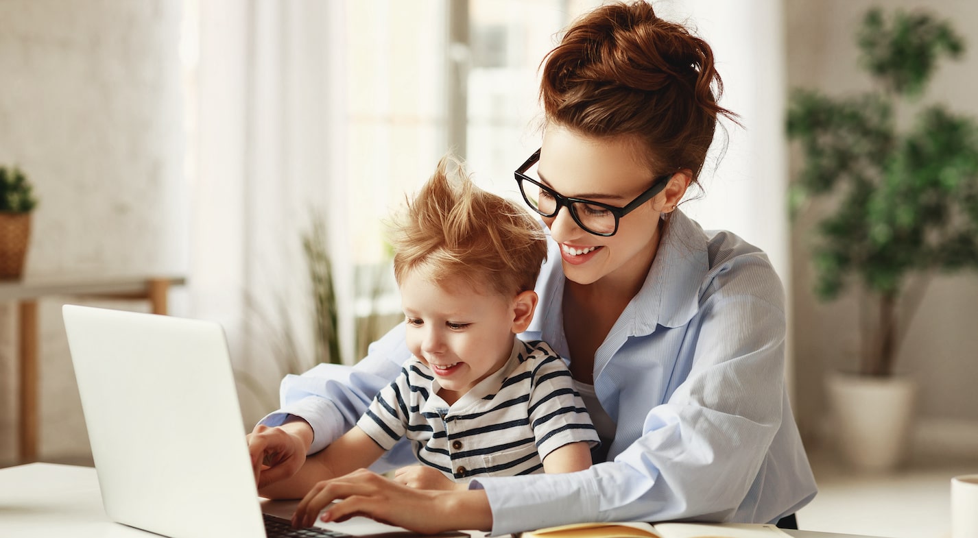 a woman working from home with her child