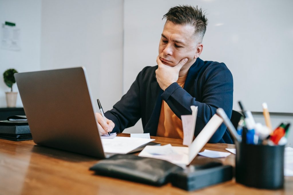 a man looking at computer market trends for beauty goods