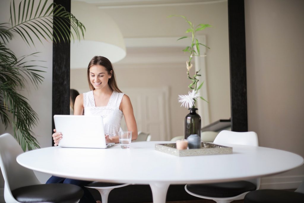 woman in a room with a notebook cover for why get an ecommerce store