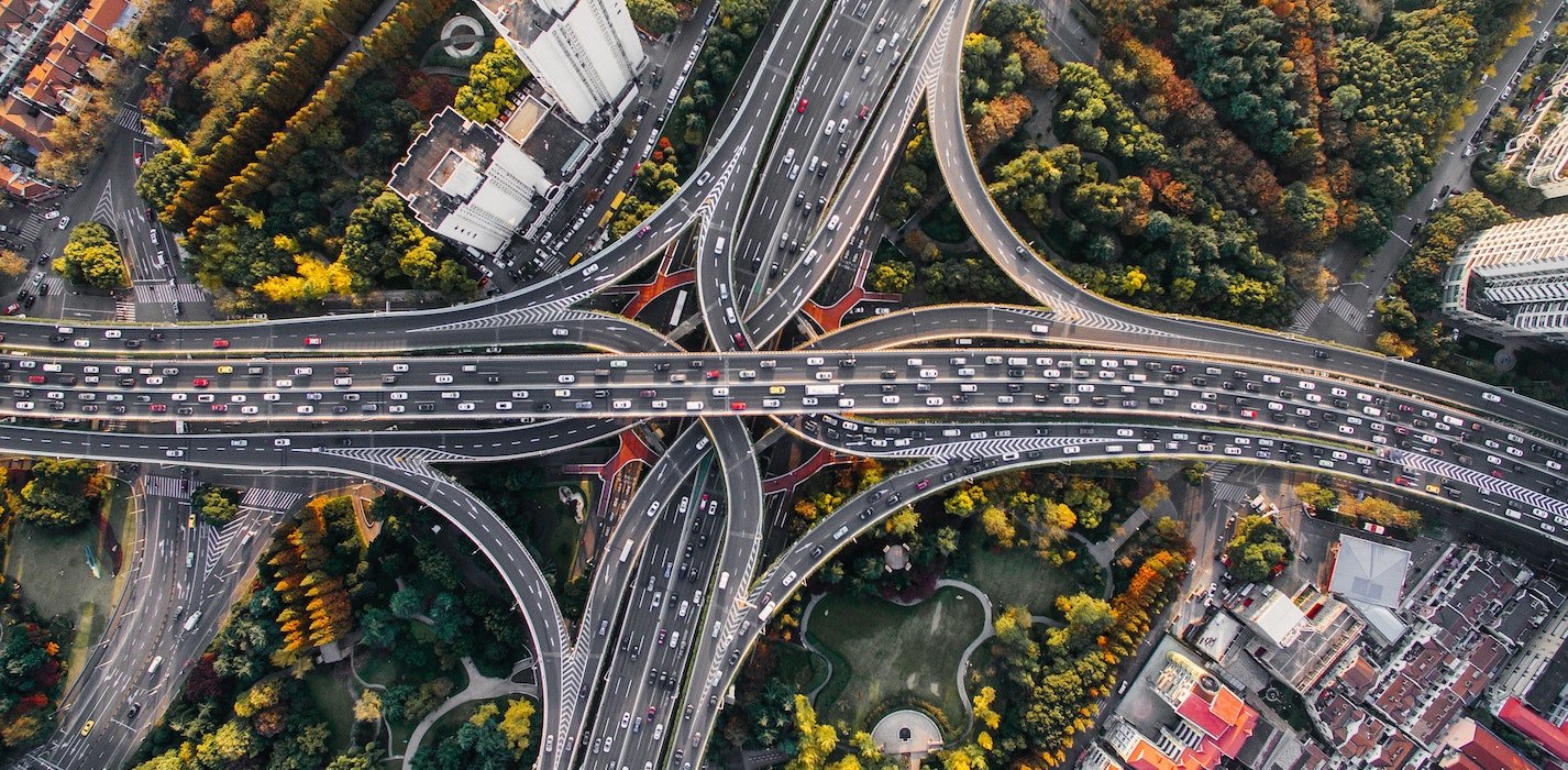 a picture showing lots of car owners on the road willing to stand out of the crowd