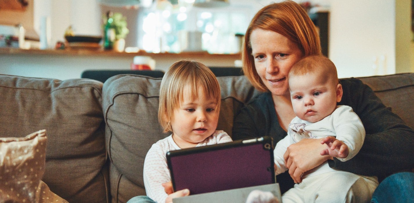 a picture showing a woman shopping online with kids