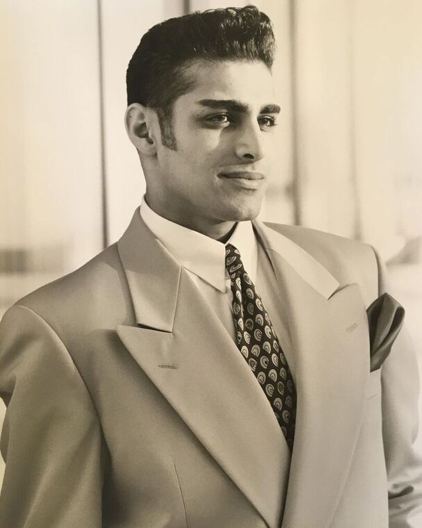 Photo of young Manny Khoshbin wearing a suit