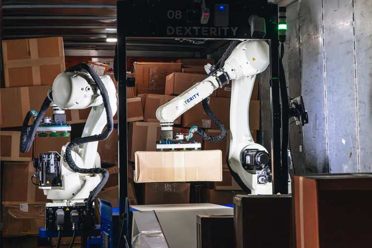 Photo showing robotic arms sorting packages