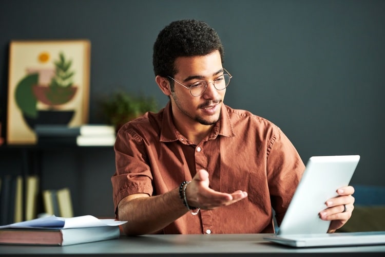 Photo of a man looking at his tablet