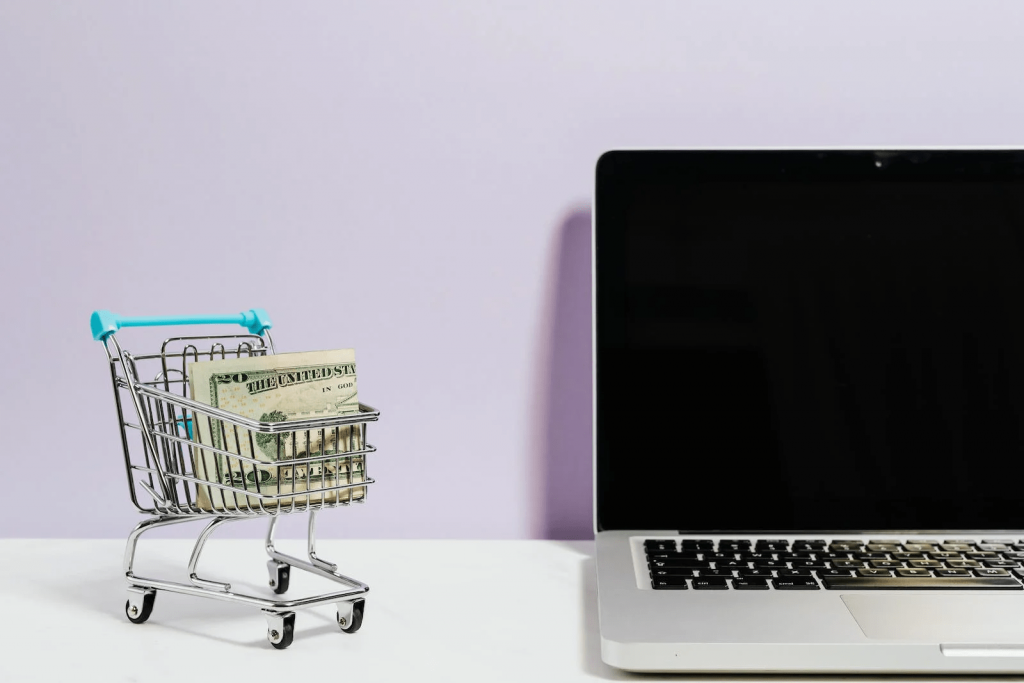 picture of a laptop next to a shopping cart