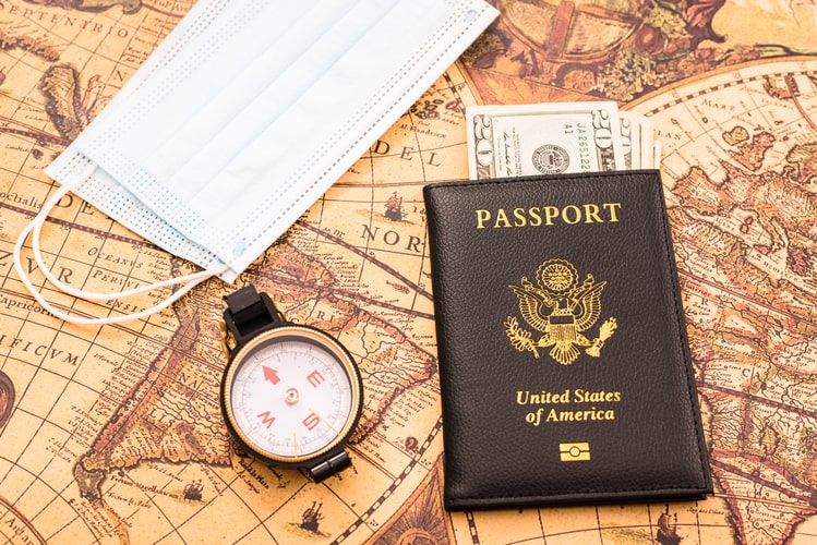 Picture of the US passport and a map with a compass