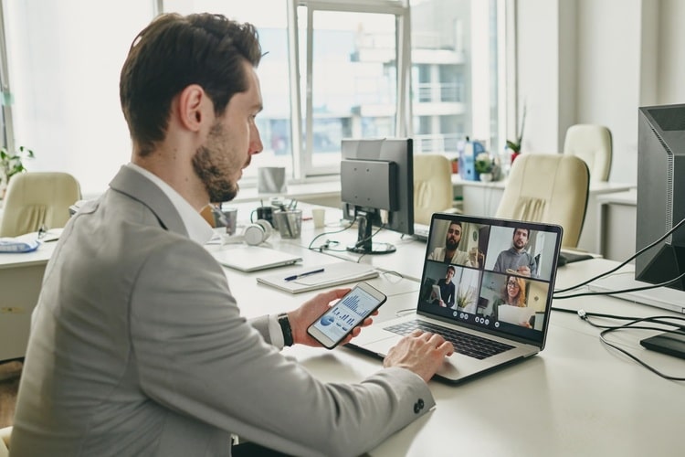 Picture of a man talking to colleagues on zoom